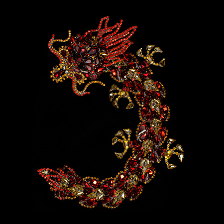 Handmade rhinestone brooch with a red Chinese dragon.