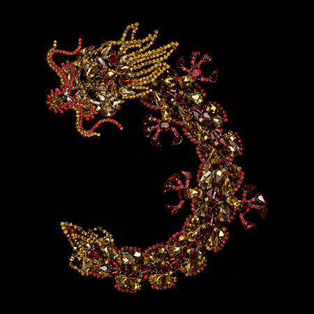 Handmade rhinestone brooch with a yellow Chinese dragon.